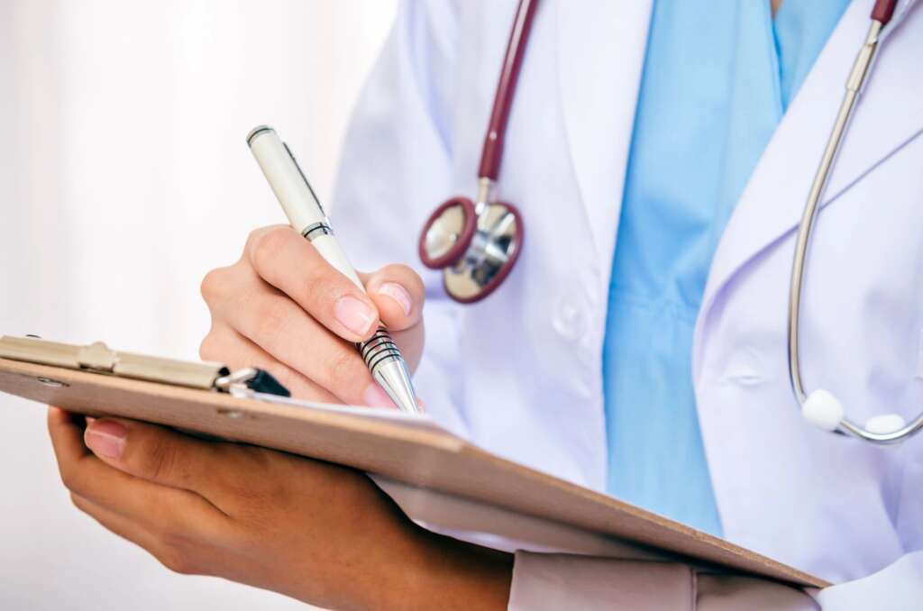 Direct Primary care clinic in el paso, texas doctor with a clip board.